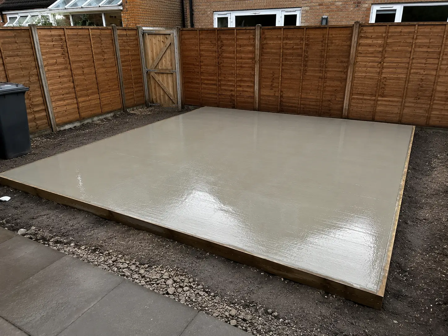 Concrete base installation for outside structure